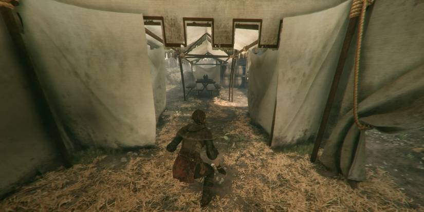 A table near the tent where the sleeping soldiers are in A Plague Tale: Innocence.