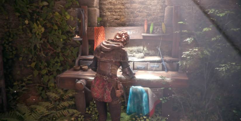 Amicia upgrading her skills on a workbench in A Plague Tale: Innocence.
