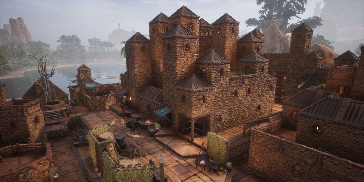Conan Exiles large base nestled in near the water