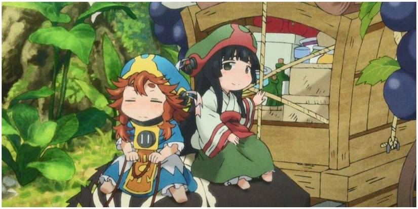 Two incredibly small people on a carriage.