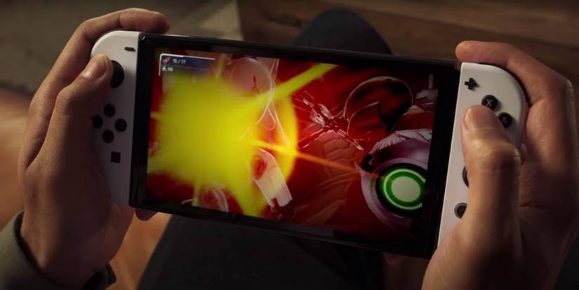 Hands holding Switch OLED