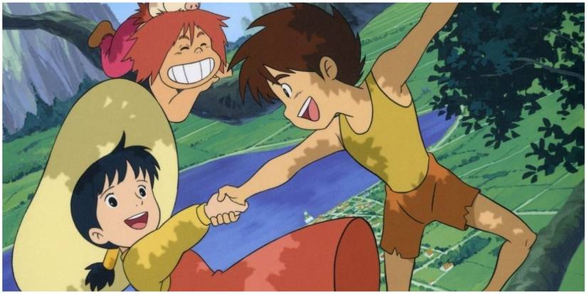 A young boy holding the hand of a girl as he climbs a tree