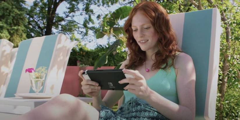 Hands holding Switch OLED