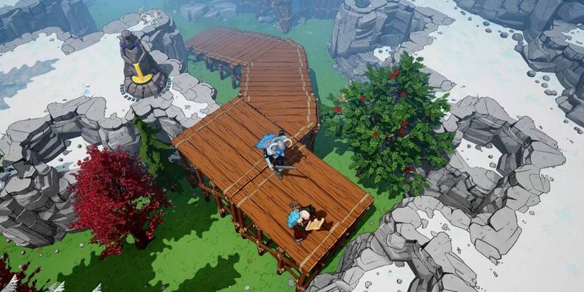 Tribes of Midgard players building a bridge across a snowy gap