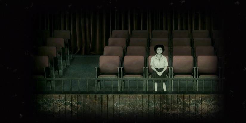 Girl sitting alone surrounded by empty chairs