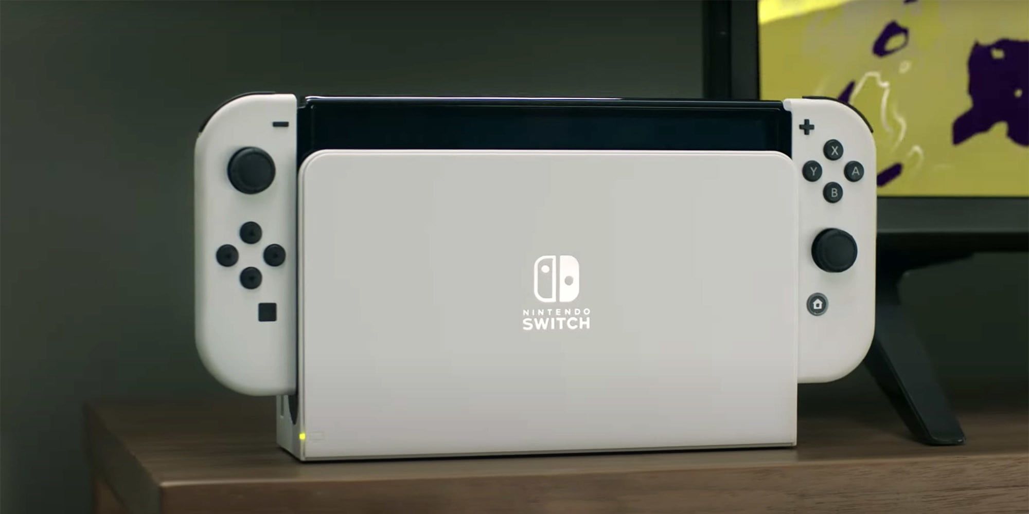 white Nintendo Switch OLED, in dock