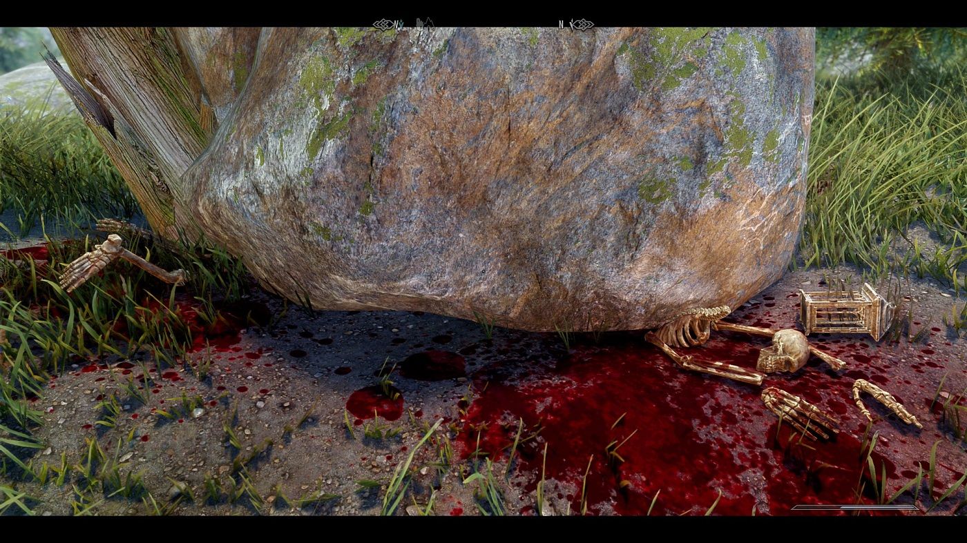 Screenshot from Skyrim showing a sjeleton crushed under a boulder.