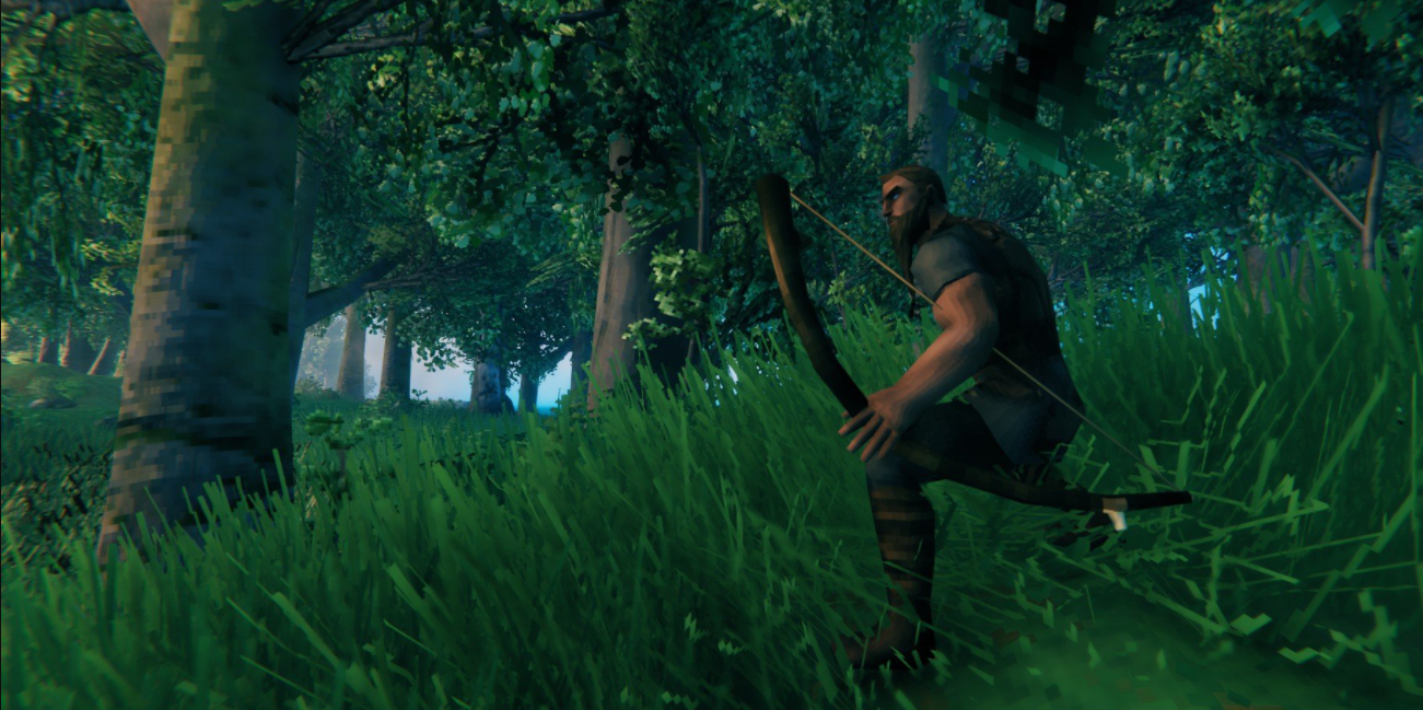 player crouching in grass with a simple wooden bow.