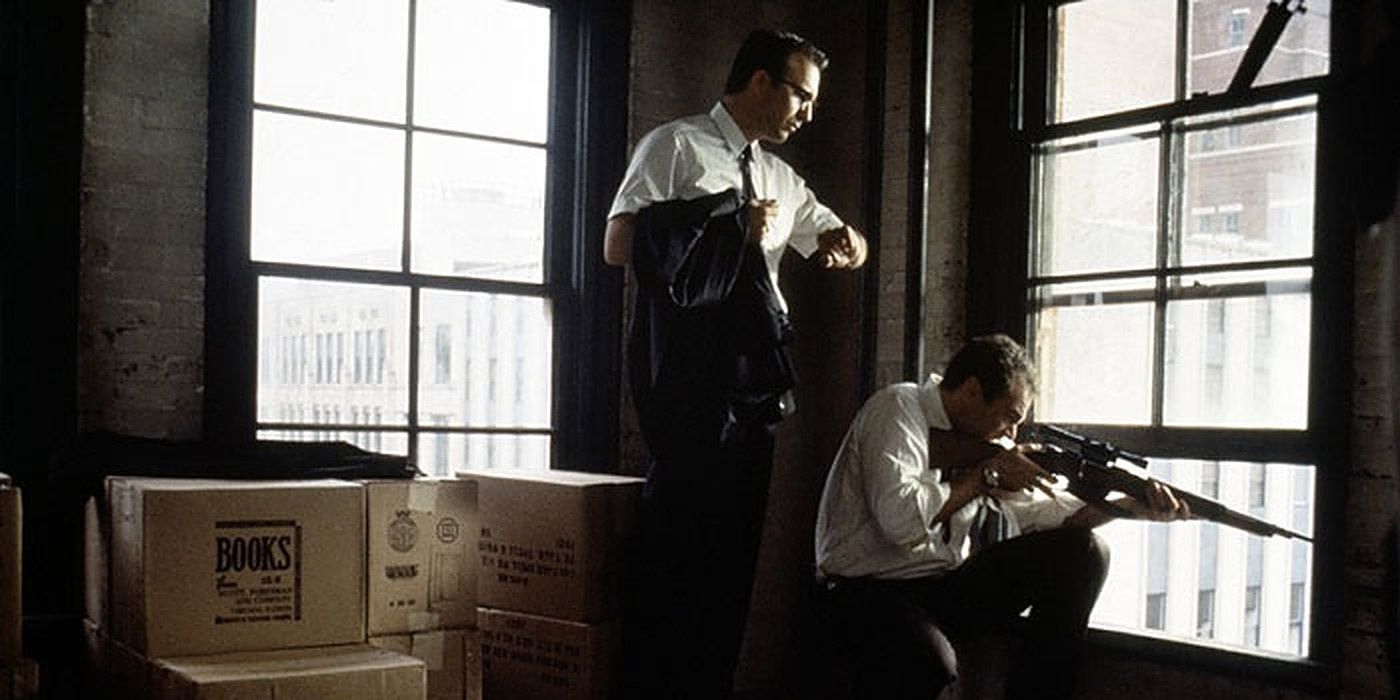 A man aims a gun from a window in JFK