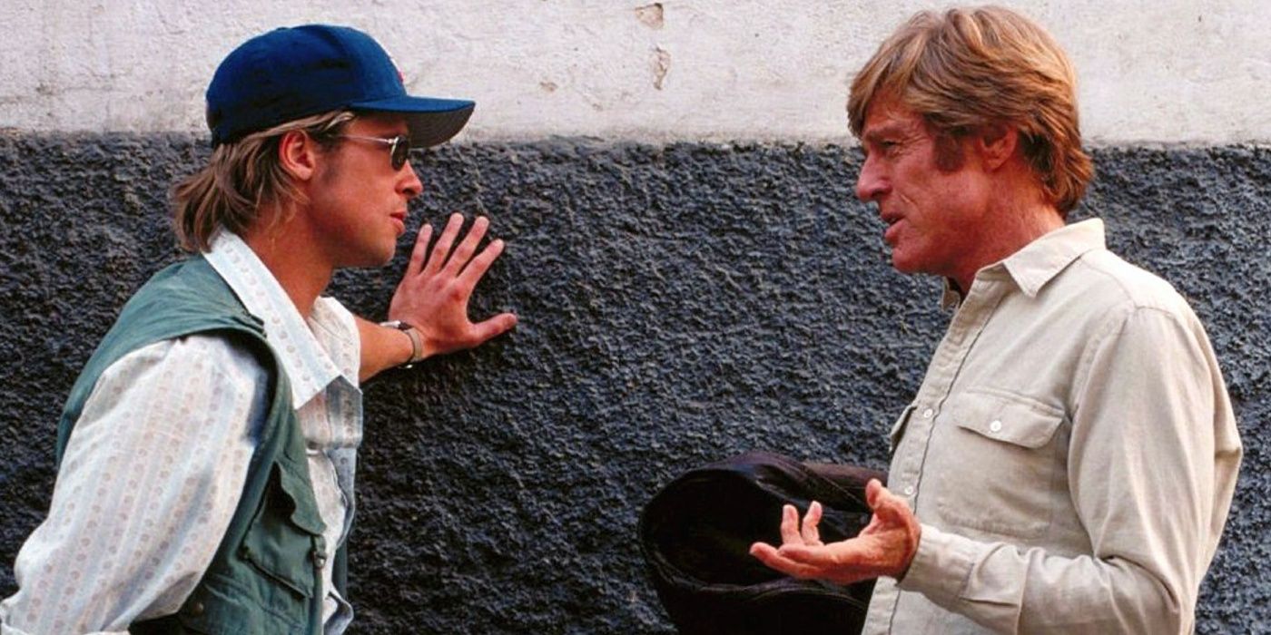 Brad Pitt and Robert Redford talking against wall in Spy Games
