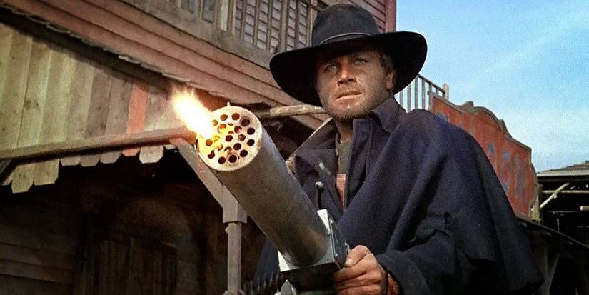 Franco Nero firing a machine gun in Django