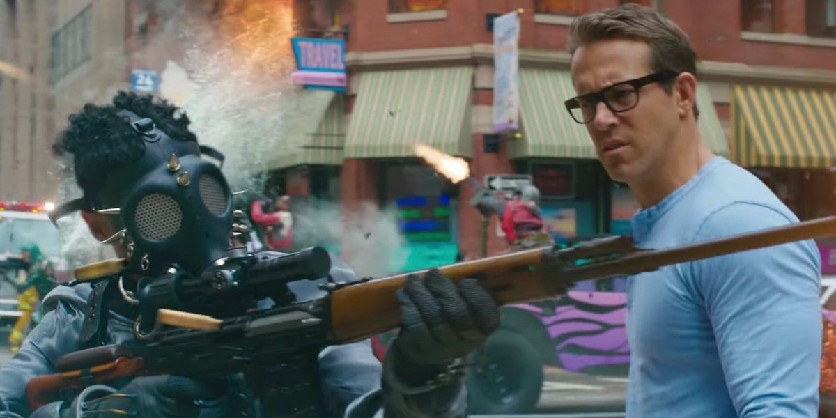 Ryan Reynolds as Guy looking at Free City player with a gas mask and gun in Free Guy