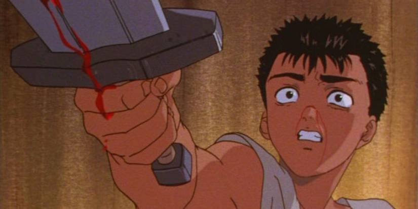 Guts uses his sword to defend himself