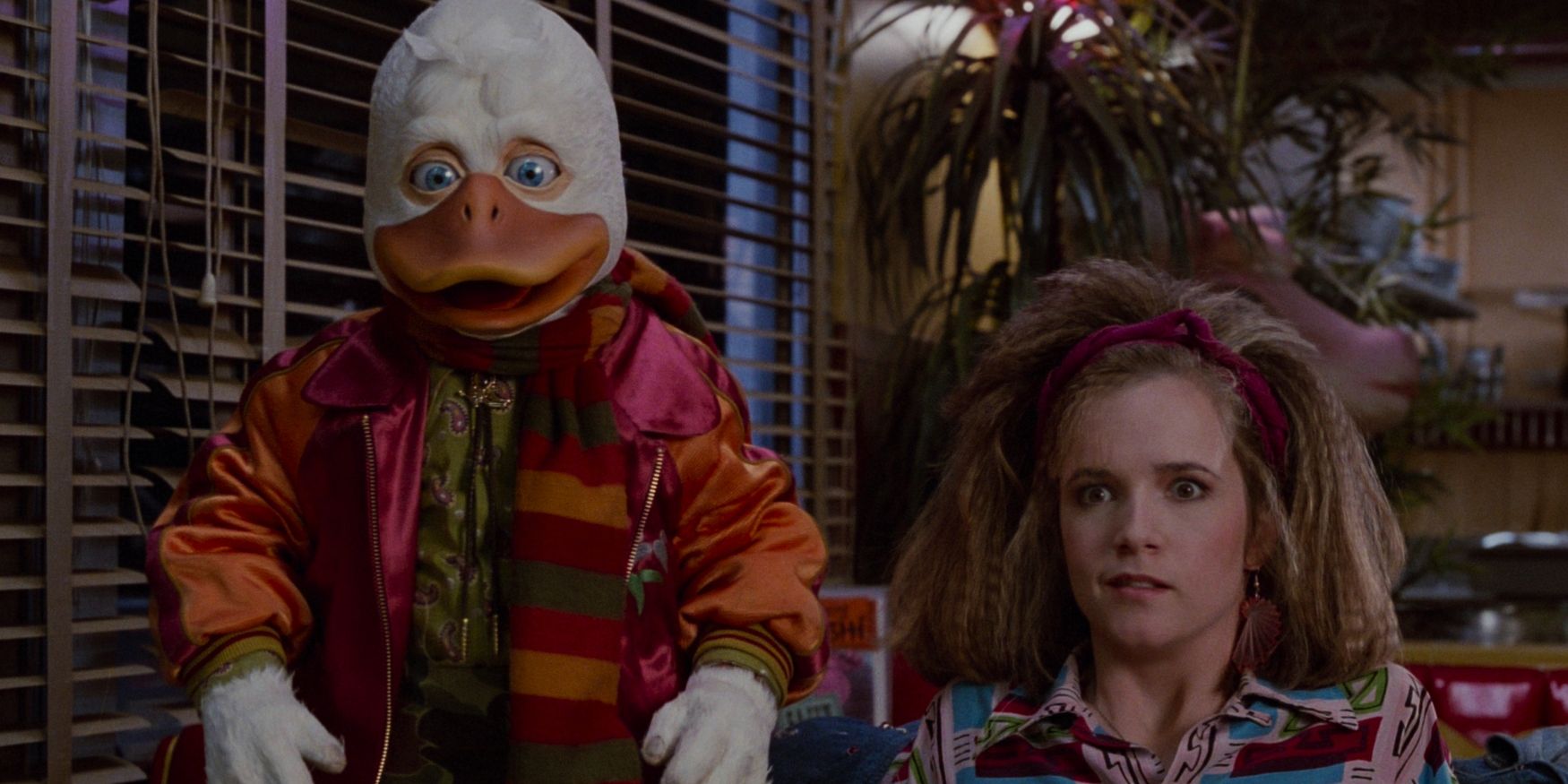 Howard, Beverly, and Dr. Jennings sit at a diner in a scene from 'Howard the Duck'