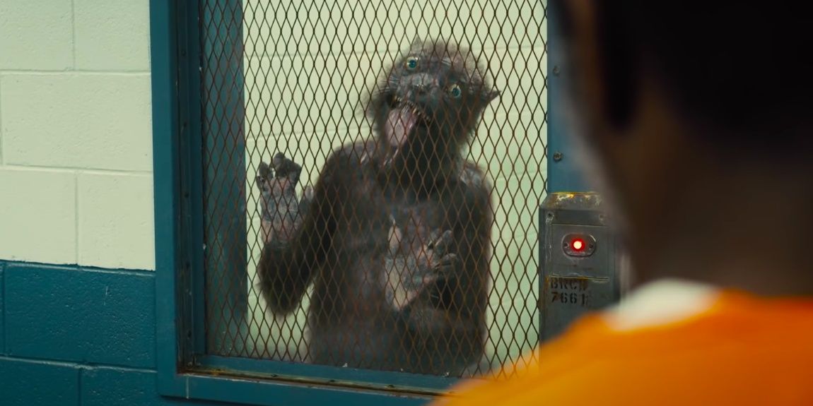 Weasel licks the door of his cell in The Suicide Squad