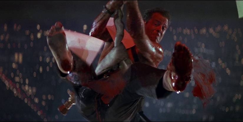 John McClane trying to kick through a window in Die Hard