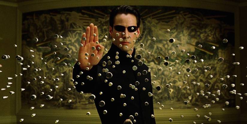 Neo defeats the agents by stopping their bullets mid-air in a scene from 'The Matrix'.