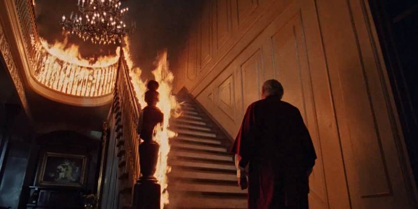 A priest walks up burning stairs in The Changeling