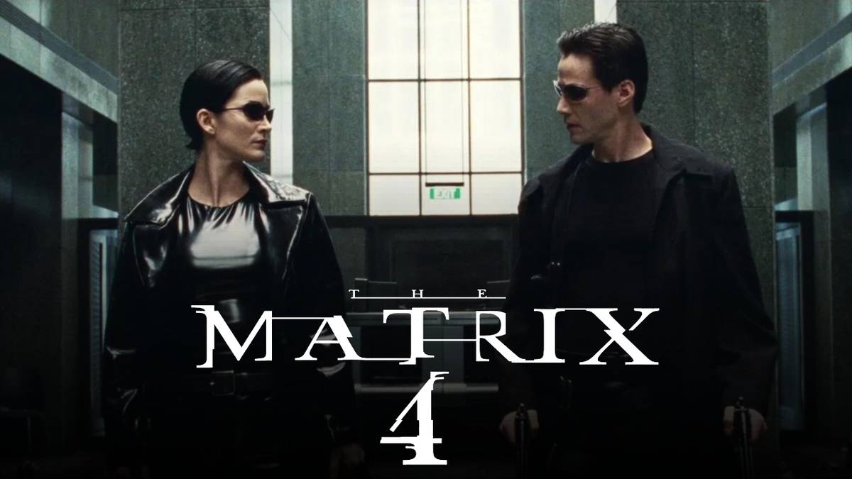 Neo and Trinity glance at each other during the lobby shootout in 'The Matrix'