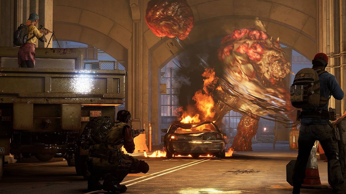 A screenshot from Back 4 Blood showing the Cleaners fighting an Ogre in a tunnel.