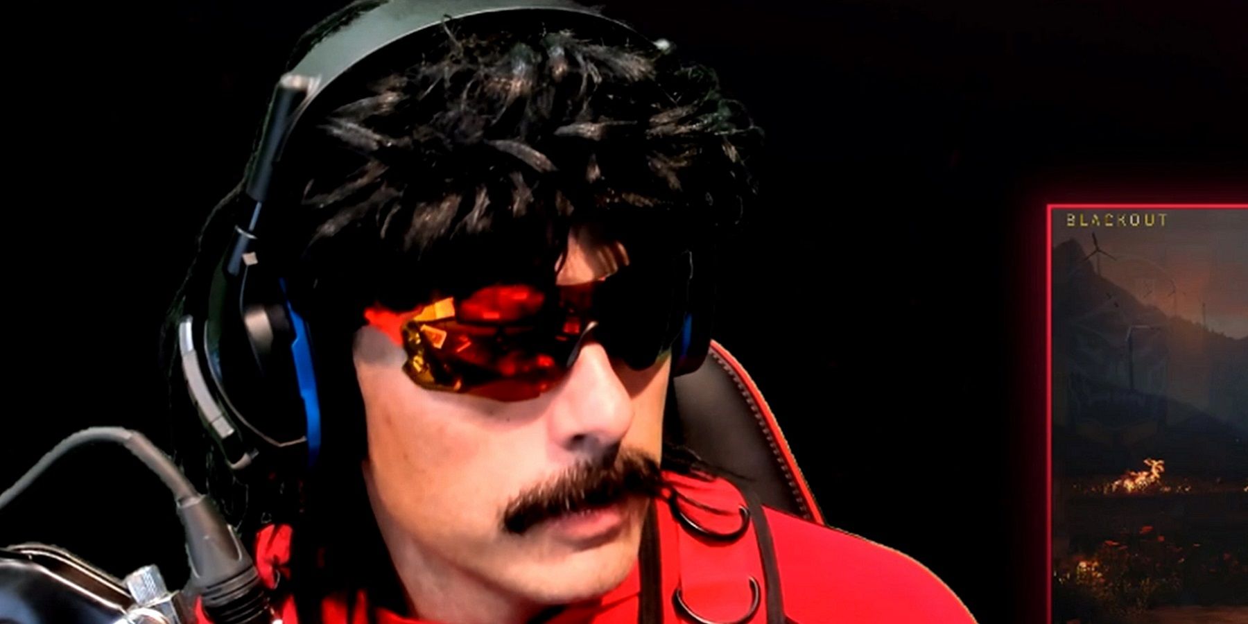 Close up of YouTube streamer Dr Disrespect in his trademark sunglasses and wig,
