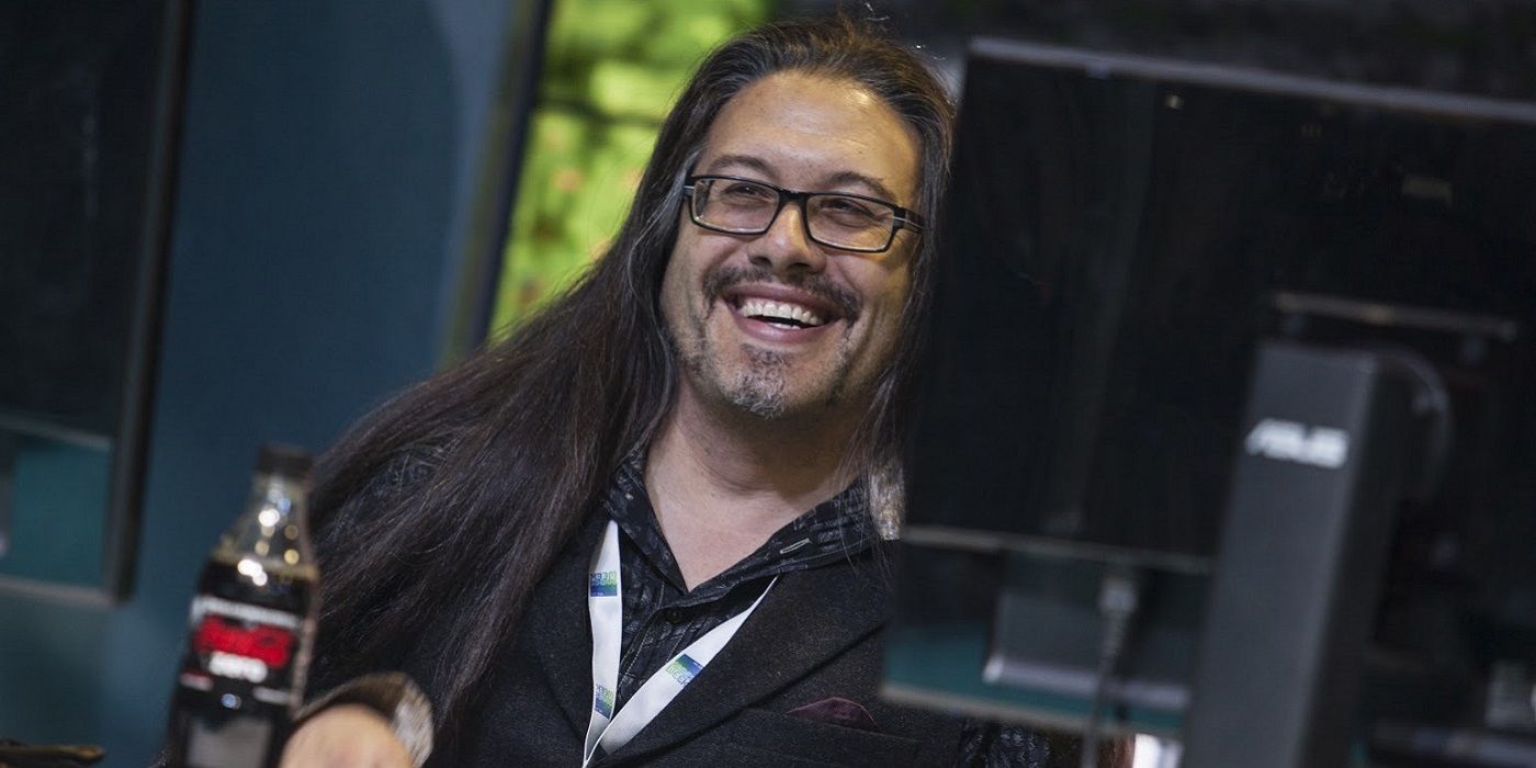 Photo of John Romero, formerly of id Software, behind a PC monitor.