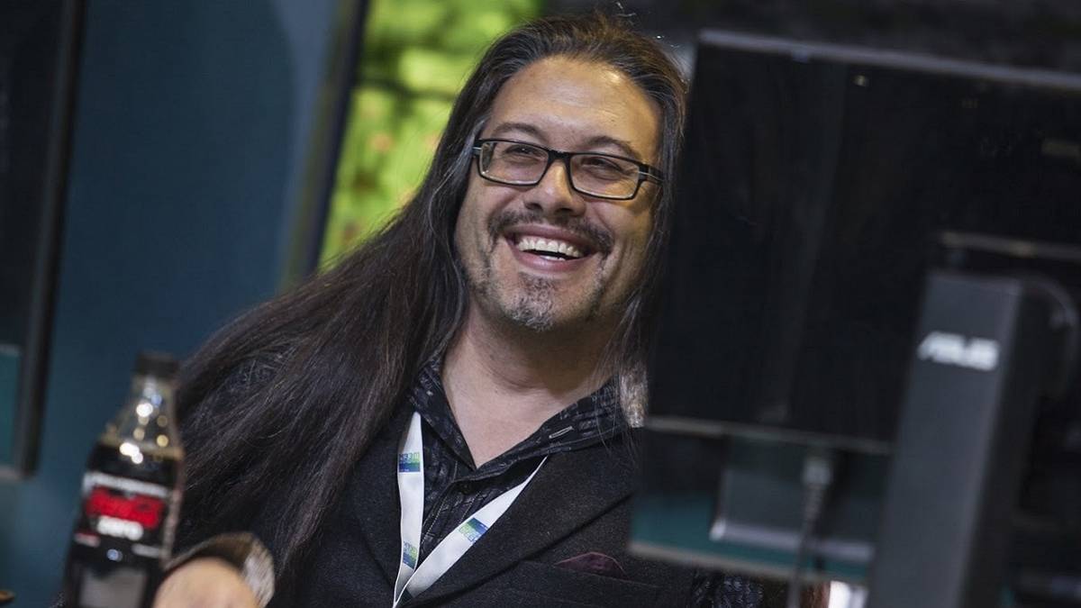Photo of John Romero, formerly of id Software, behind a PC monitor.
