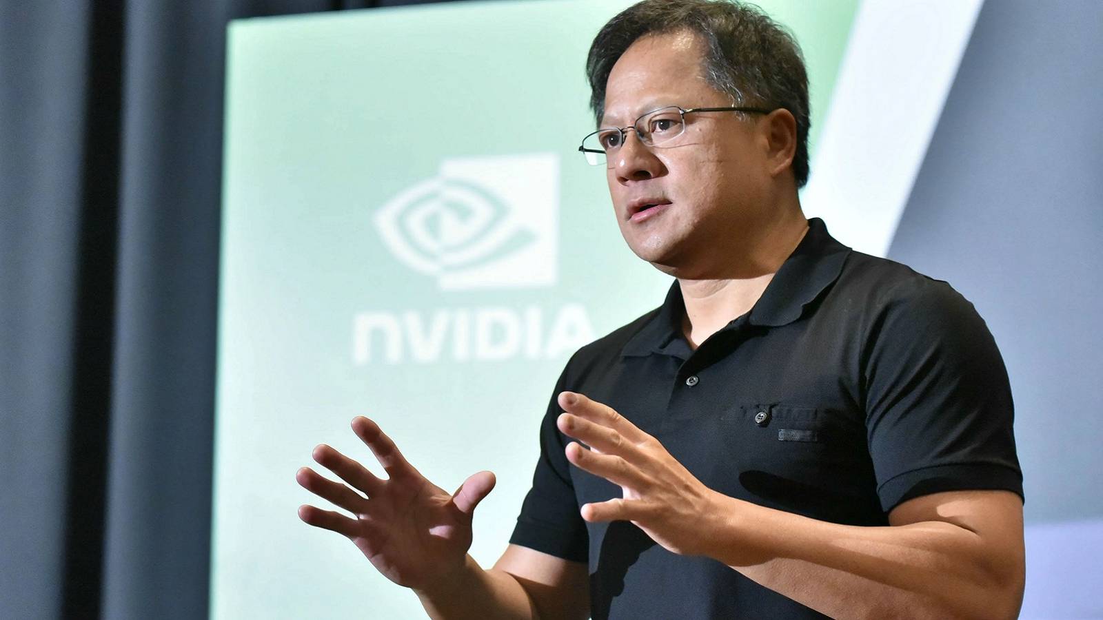 Photo showing Nvidia CEO, Jensen Huang, speaking at a conference.