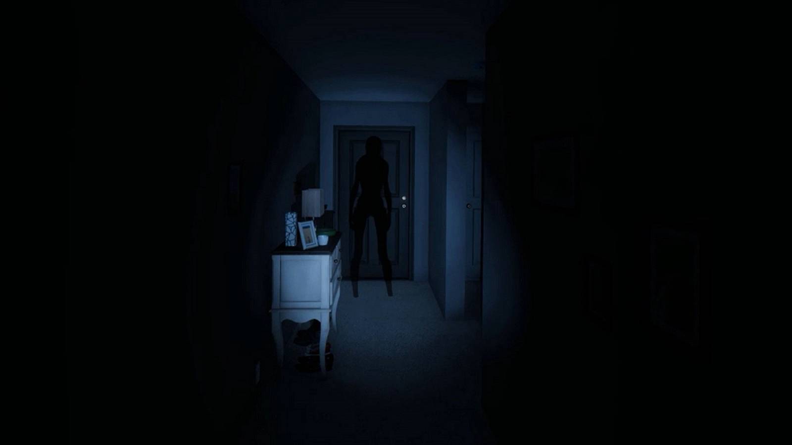Screenshot from Phasmophobia showing a flashlight shining on a silhouetted ghost down a hallway.