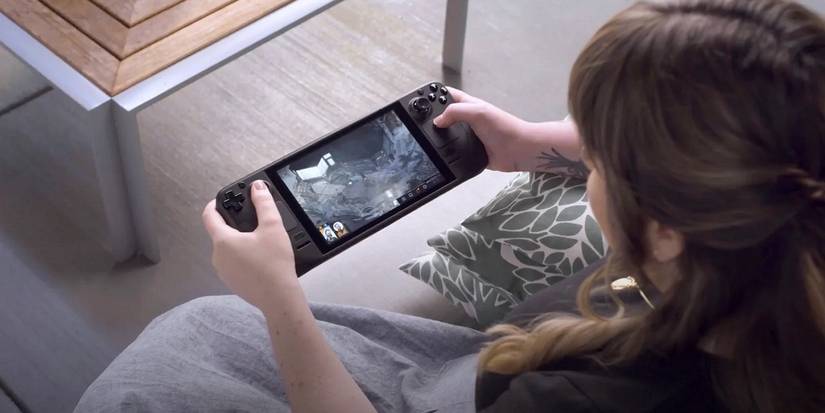 A photo of a woman holding a playing Valve's Steam Deck device.