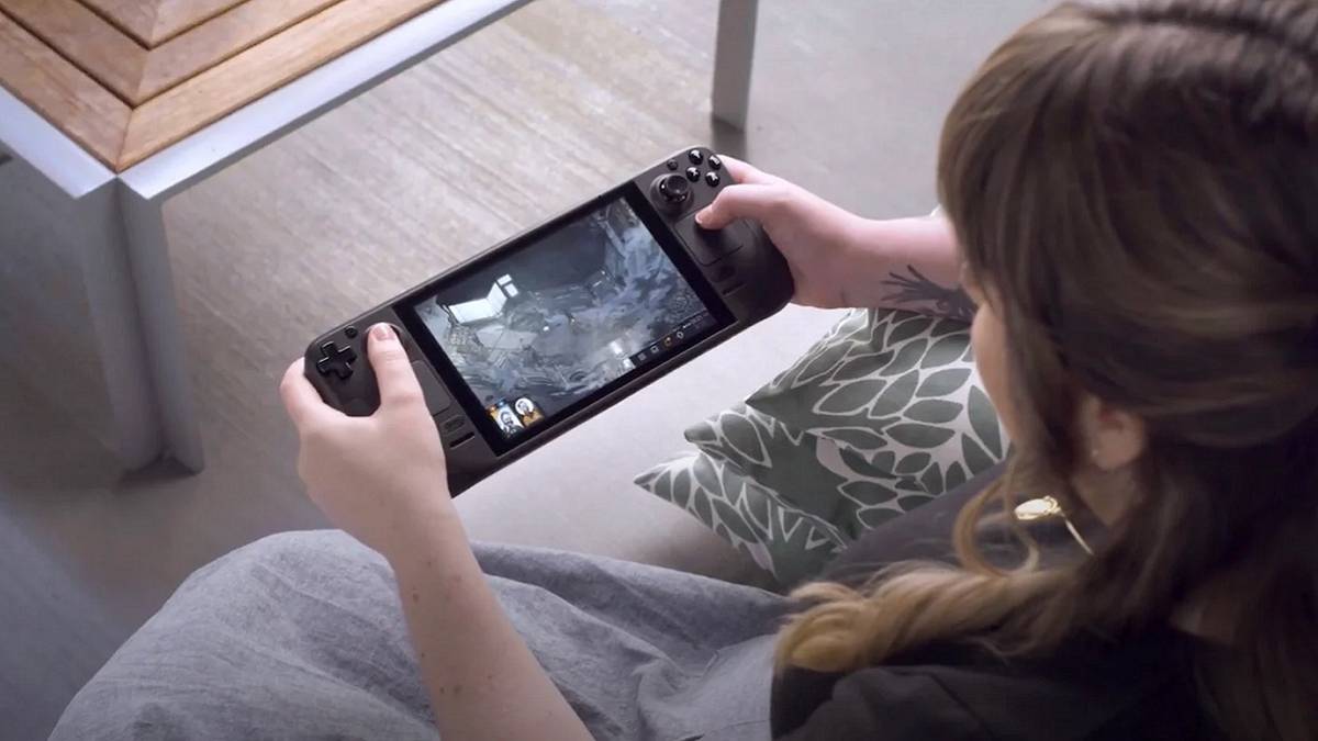 A photo of a woman holding a playing Valve's Steam Deck device.