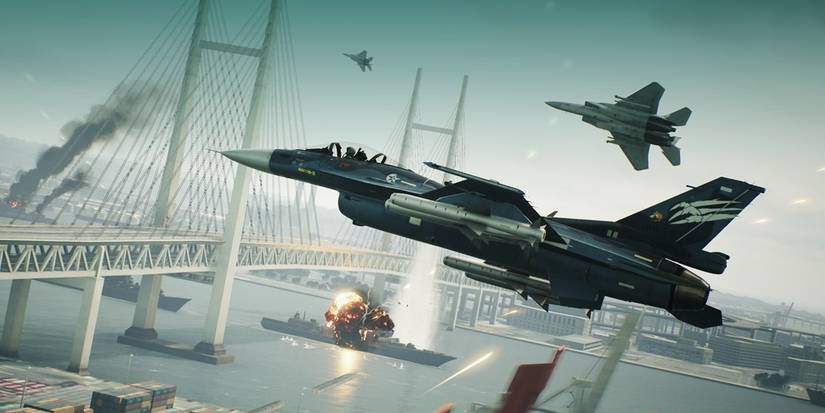 Two planes flying over a bridge dodging enemy attacks