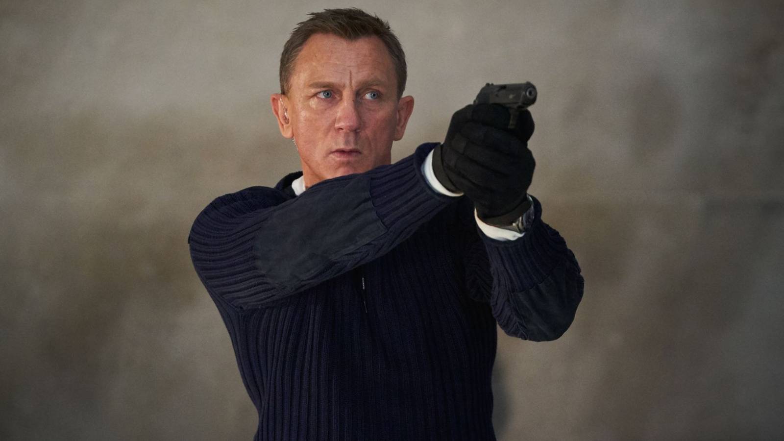 Daniel Craig holding a pistol in No Time to Die