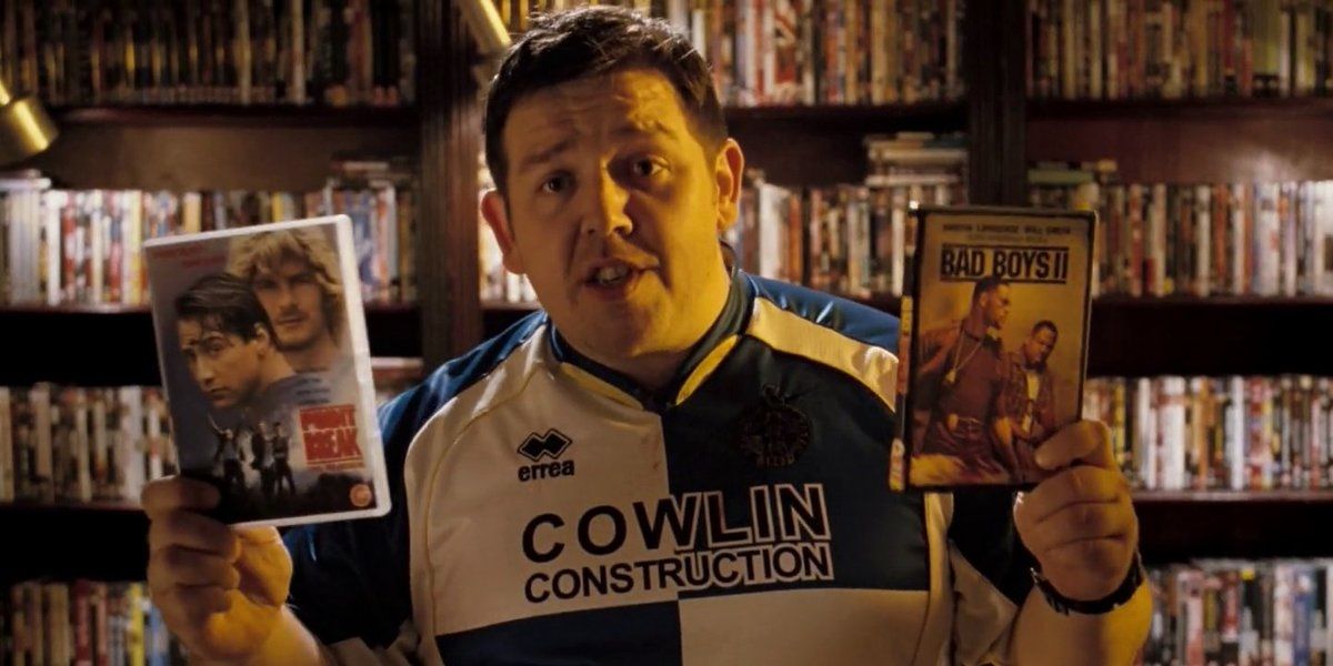 Danny holding DVDs of Point Break and Bad Boys II in Hot Fuzz
