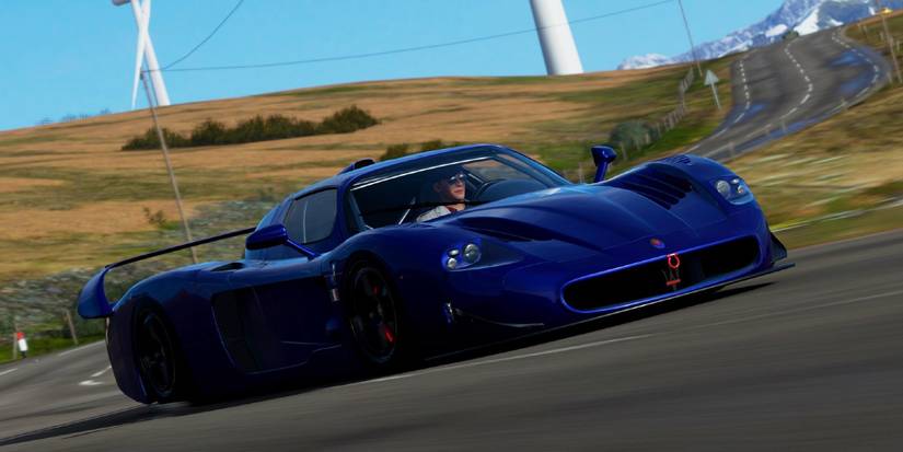 Forza Horizon 4 Maserati MC12 FE rounding turn in field three quarters view