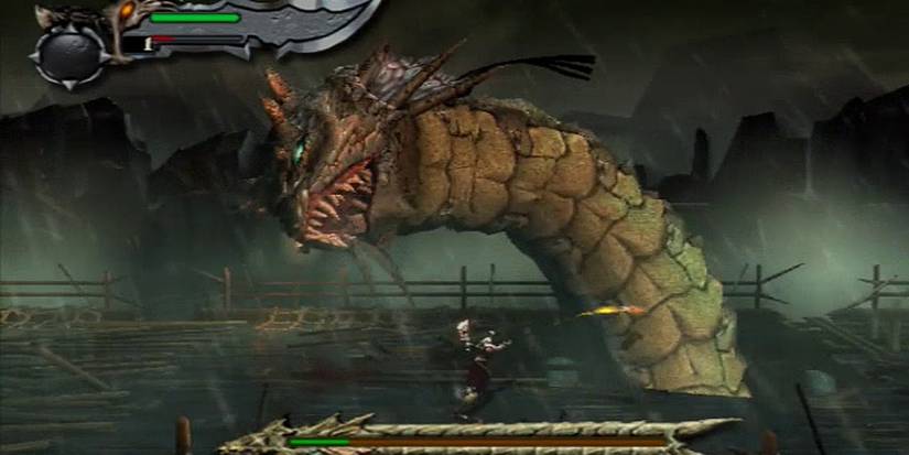 Kratos fighting dragon worm boss in rainy setting in God of War PS2