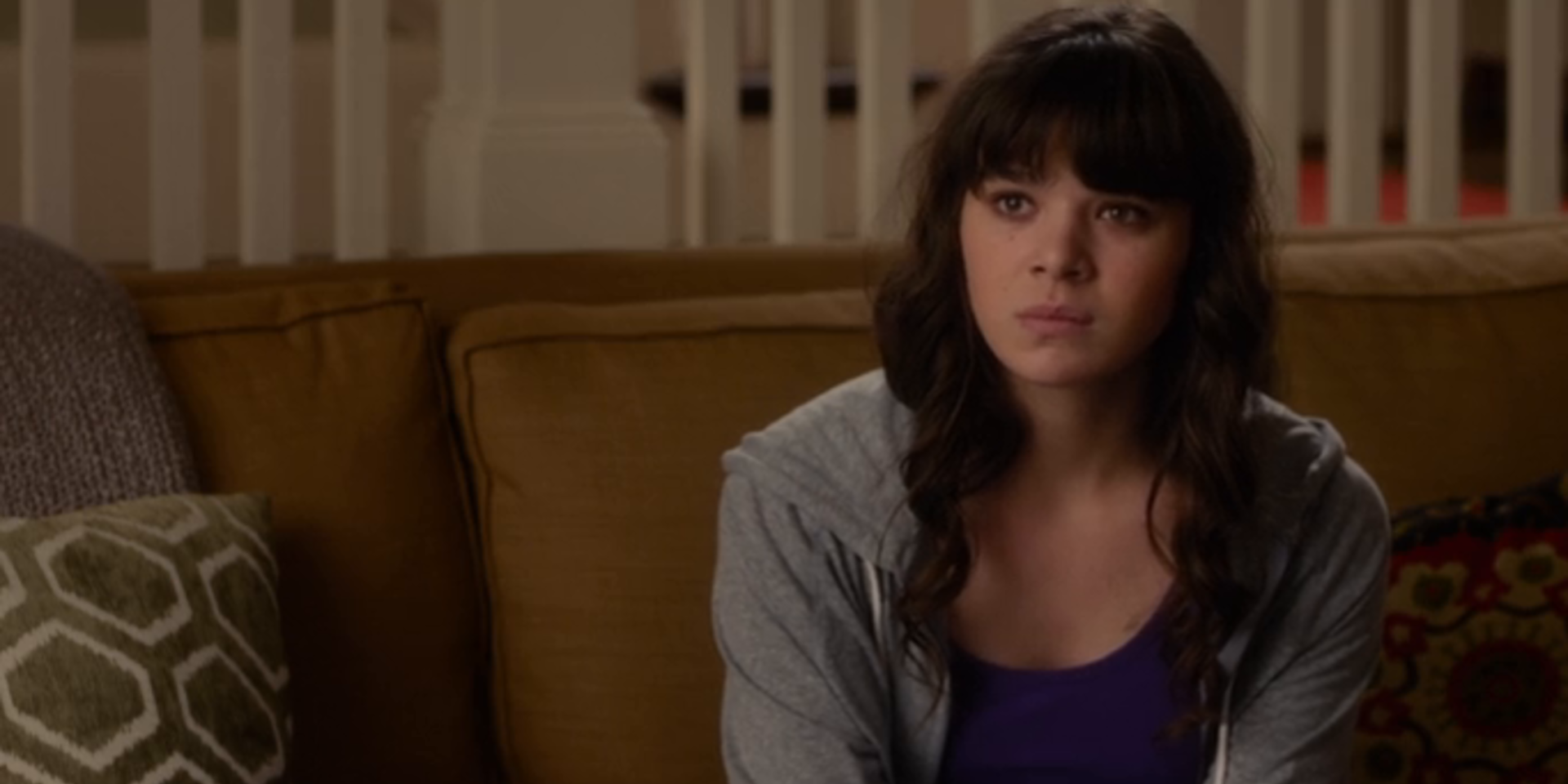 Hailee Steinfeld sits on a couch in Barely Lethal