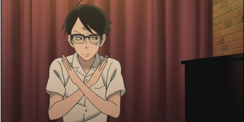 Kaoru from Kids on the Slope anime with his arms crossed in an X beside a piano