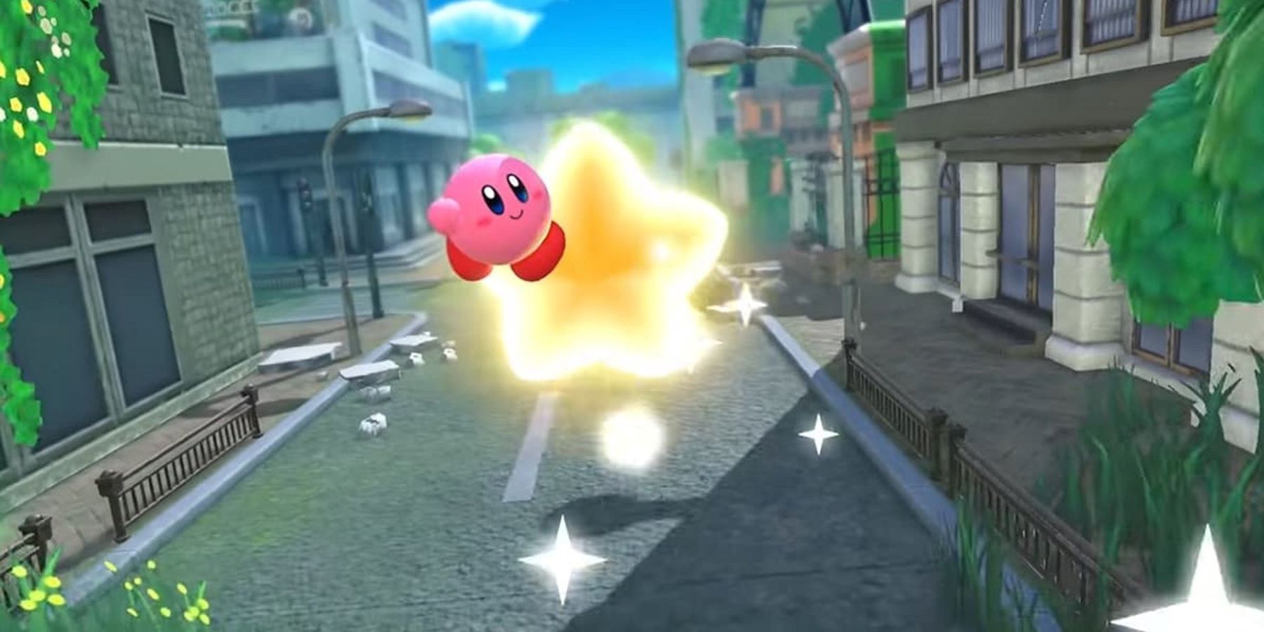 Kirby flying down a city street on a Warp Star in Kirby and the Forgotten Land