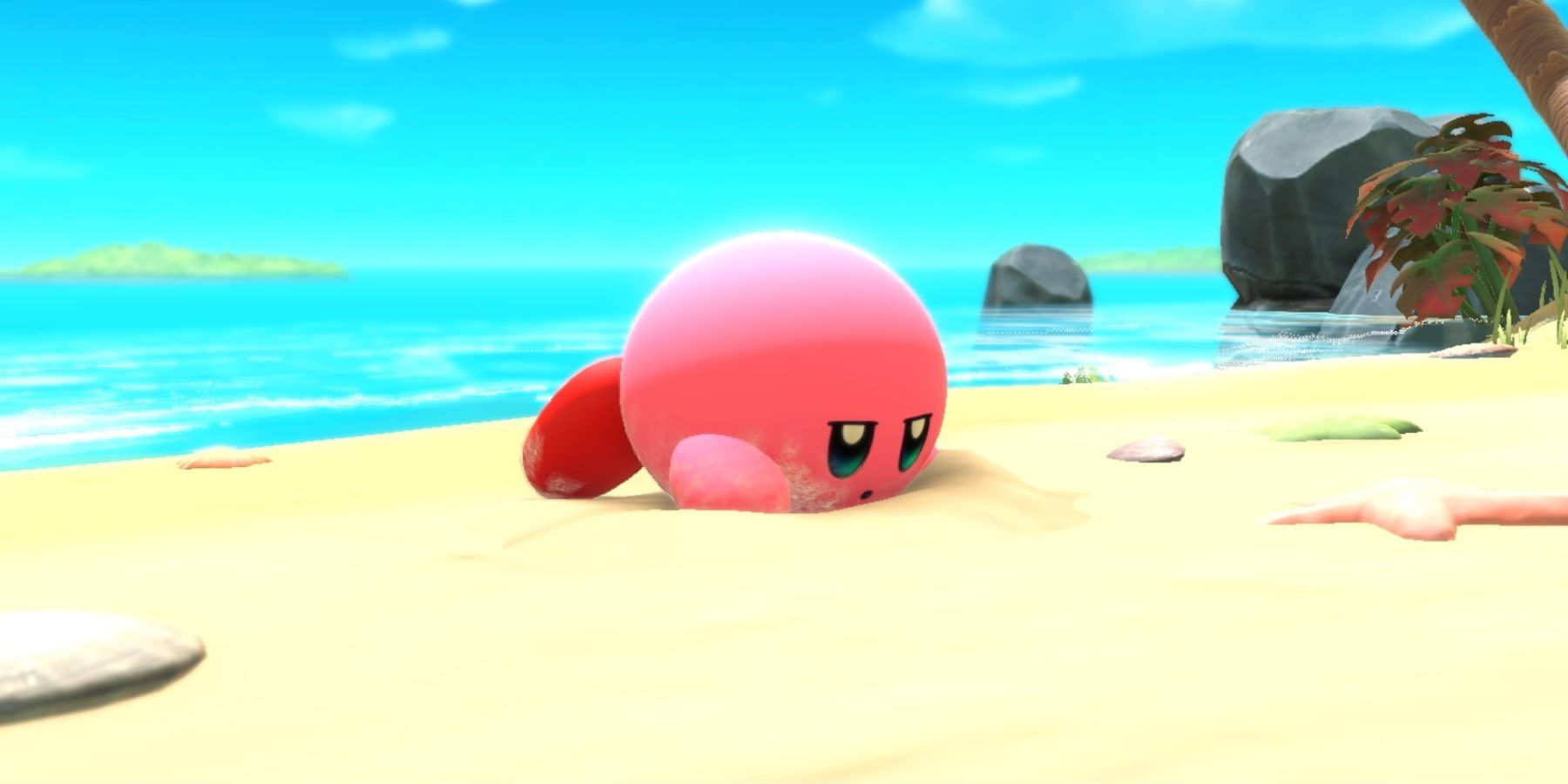 Kirby waking up on the beach in Nintendo's reveal trailer for Kirby and the Forgotten Land