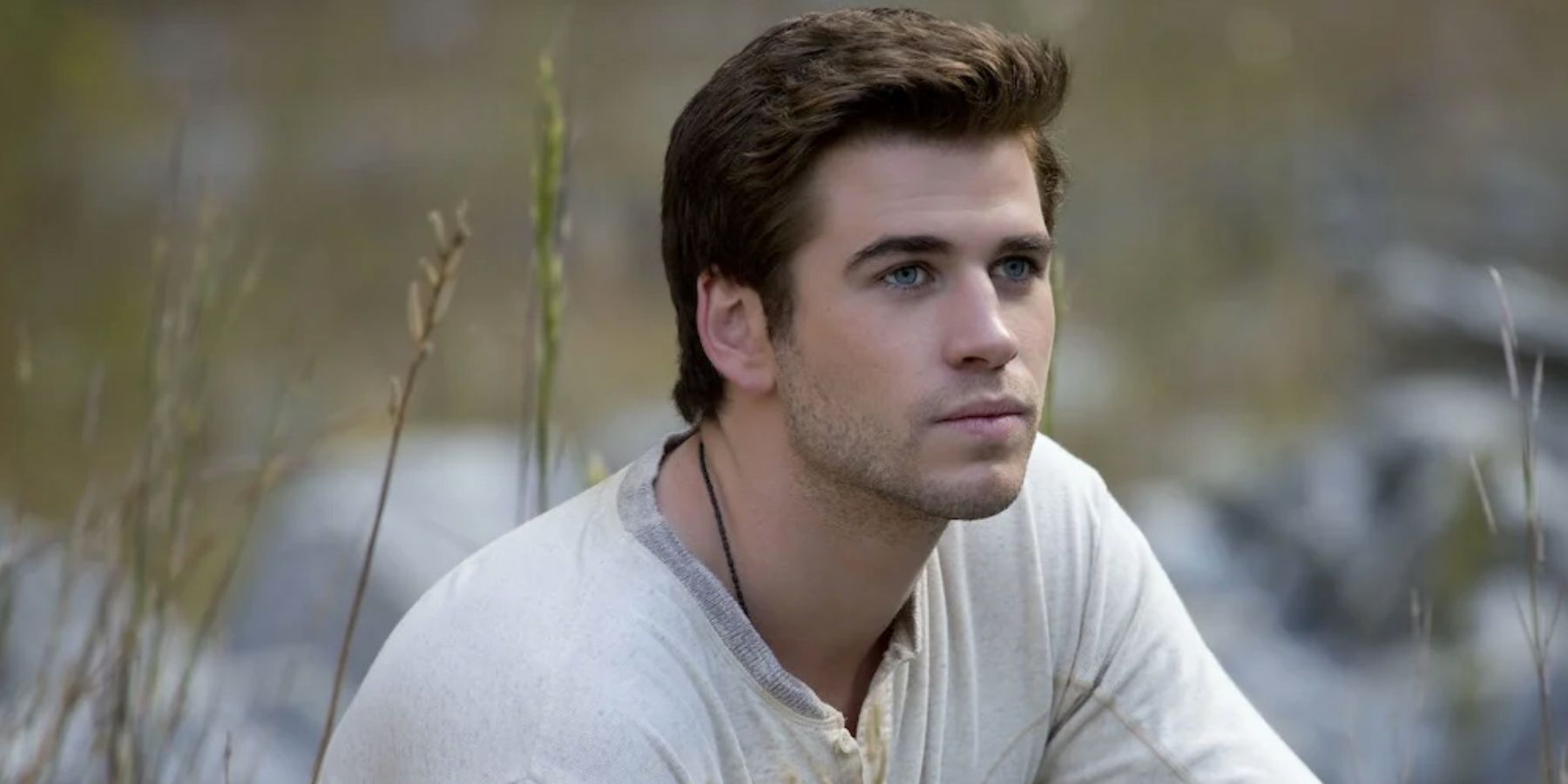 Liam Hemsworth as Gale in the grass in The Hunger Games