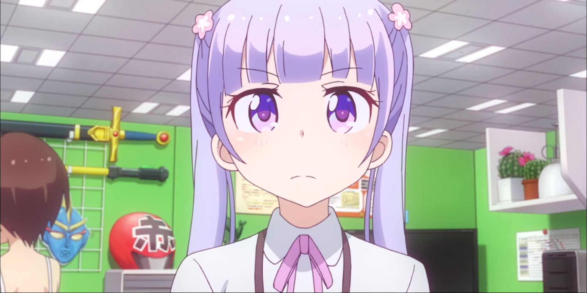 Aoba from New Game! standing in a cubicle with prop weapons on the wall