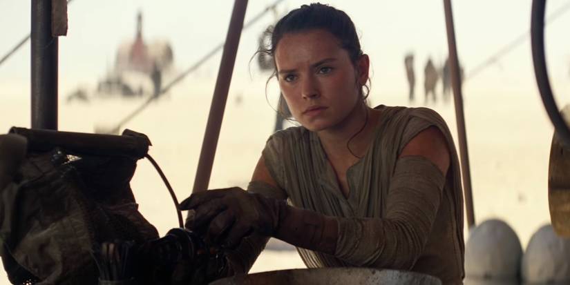 Rey at a junkyard on Jakku in The Force Awakens