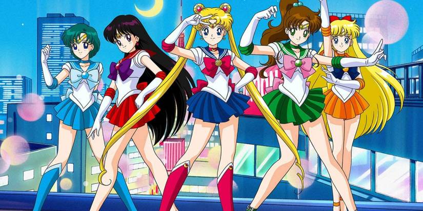 The Sailor Scouts posing on a rooftop in Sailor Moon