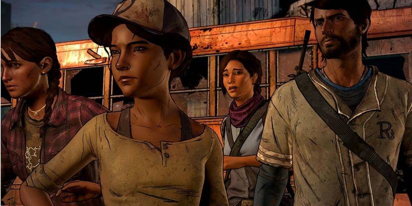 A picture of The Walking Dead characters standing outside in a line