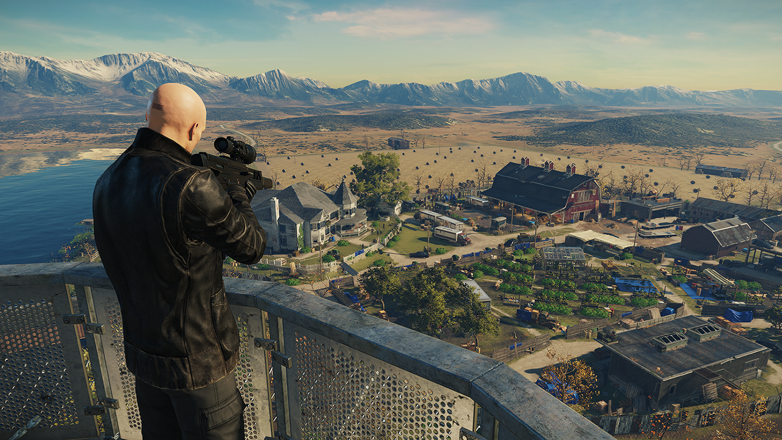 Screenshot from Hitman showing Agent 47 aiming a sniper rifle from the top of a tower.