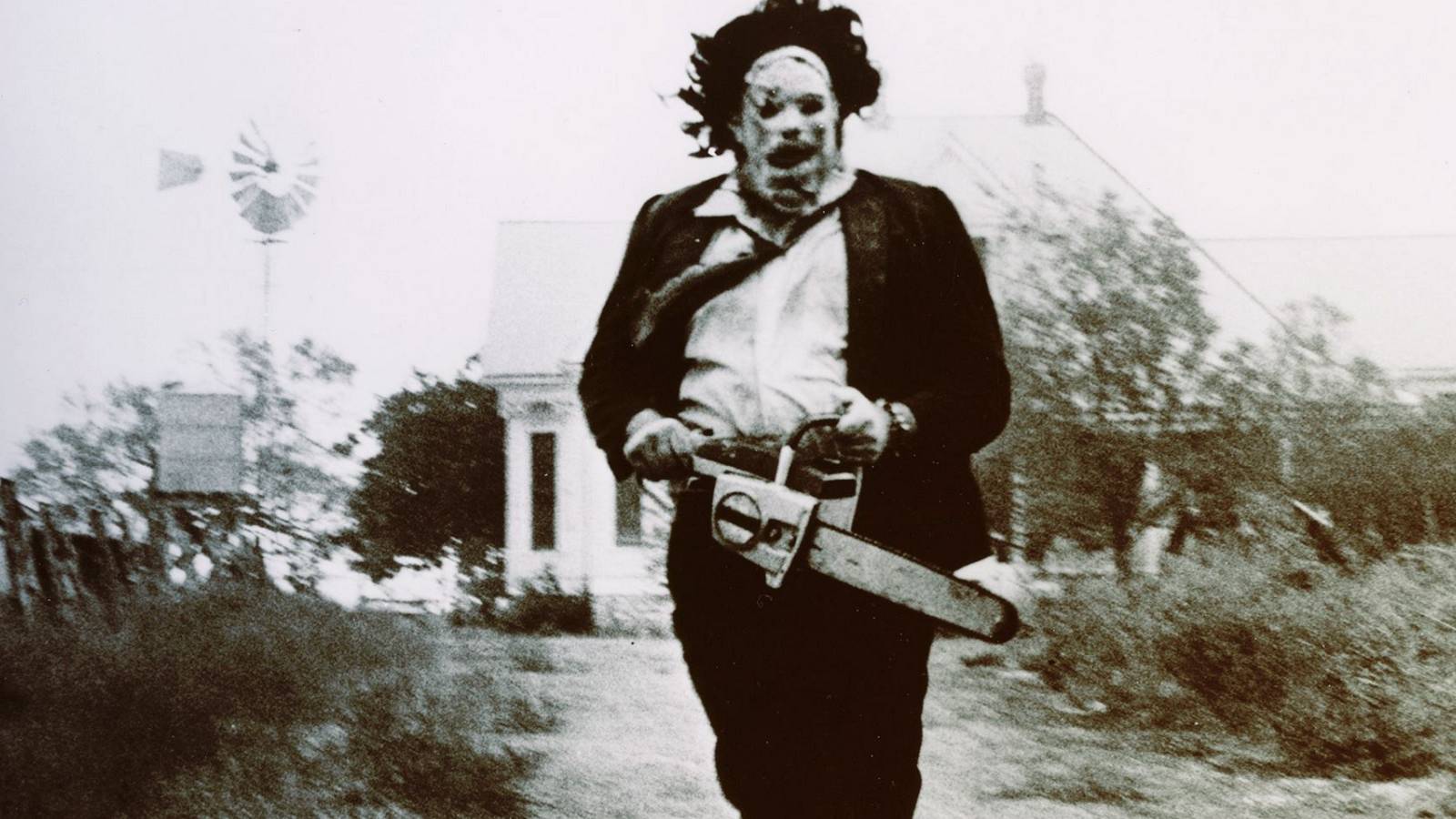 Leatherface running with his saw in The Texas Chain Saw Massacre