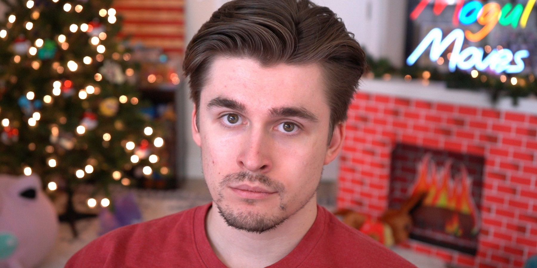 A photo of Twitch streamer and YouTuber Ludwig in front of Christmas decorations.