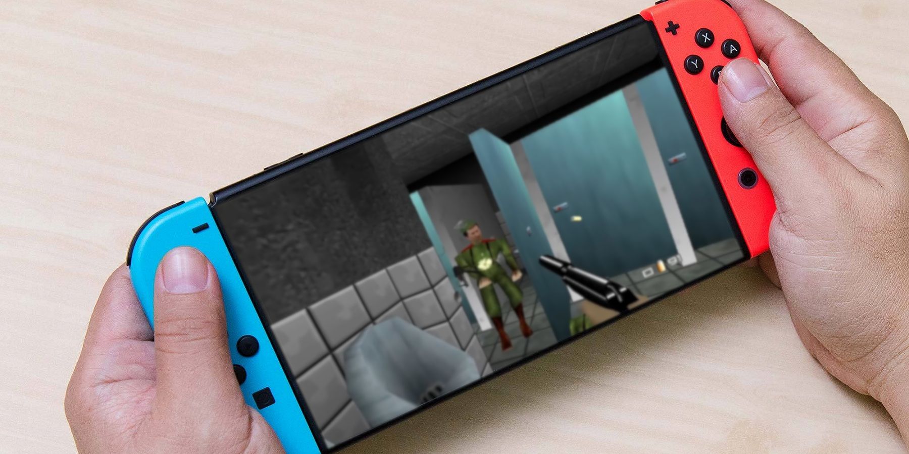 Photo of a Nintendo Switch console with a screenshot from Goldeneye 64 superimposed onto the screen.