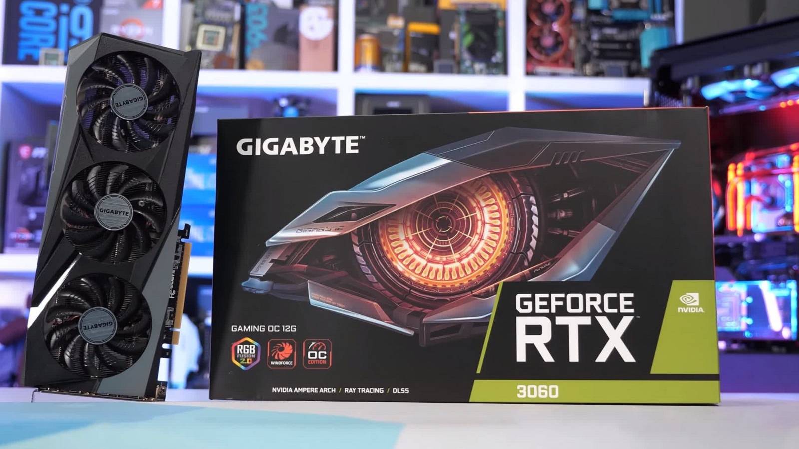 A photo showing an Nvidia RTX 3060 graphics card stood upright next to its display box.